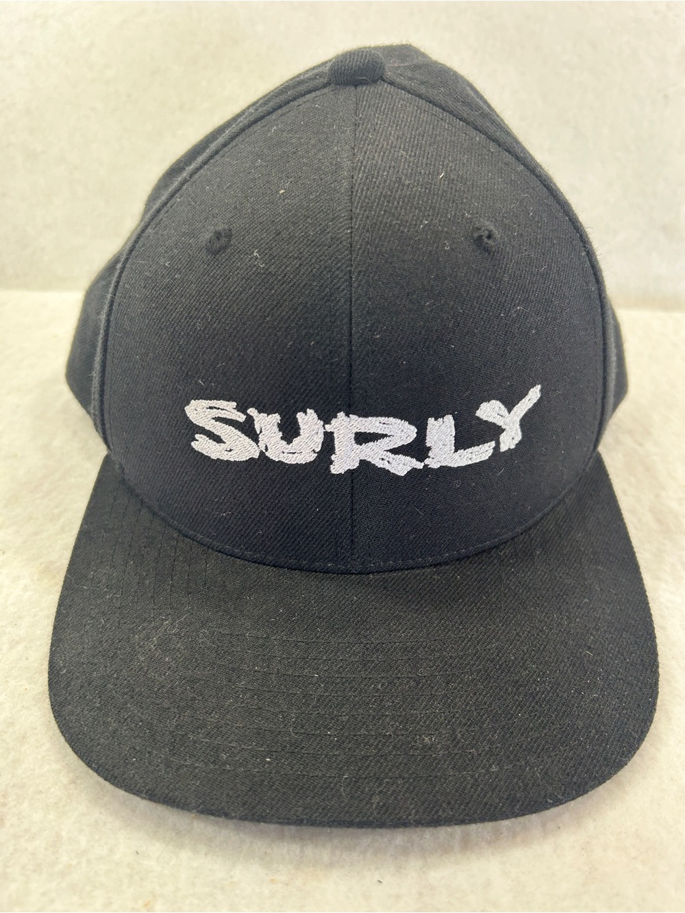 The Classic Black Hat with White 'SURLY' Embroidered Logo